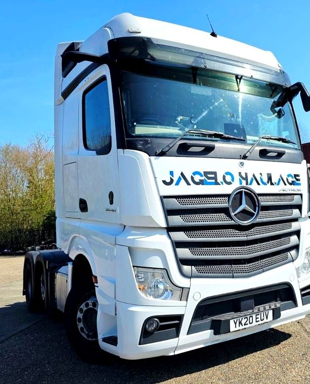 A white Mercedes Actros tractor unit in Jagelo Haulage livery, registration YK20 EUV.